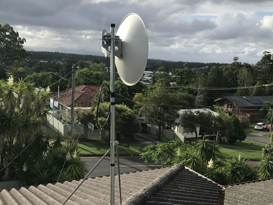 An Indigo Internet technician installing a residential fixed-wireless service